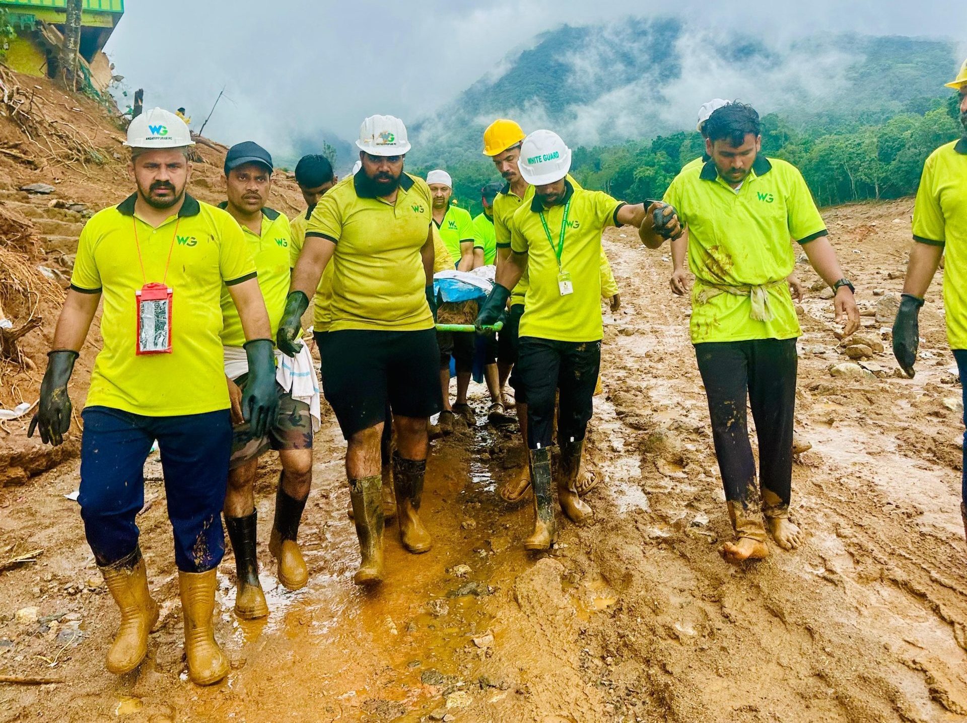 Members of the White Guard Volunteers caerry out a rescue operation in Chooralmala in Wayanad district of Kerala.